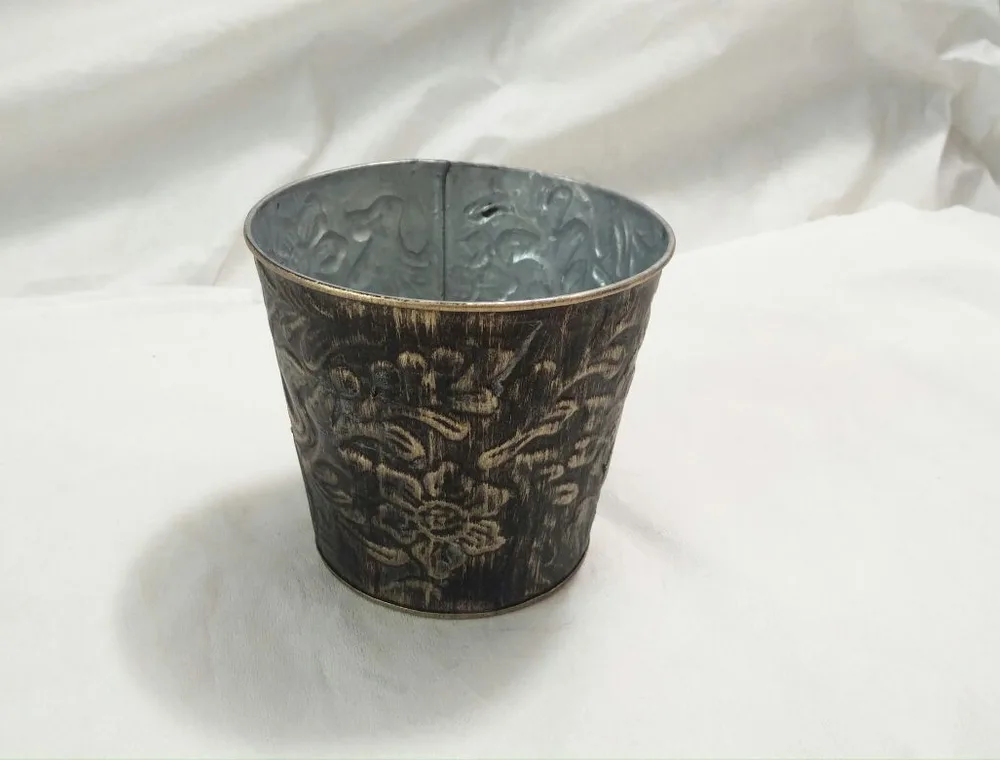Black and gold finish sample on a hammered metal pot