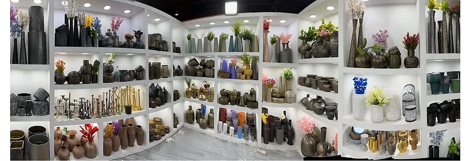 Handikraft metalware product display with planters, vases and decorative pieces
