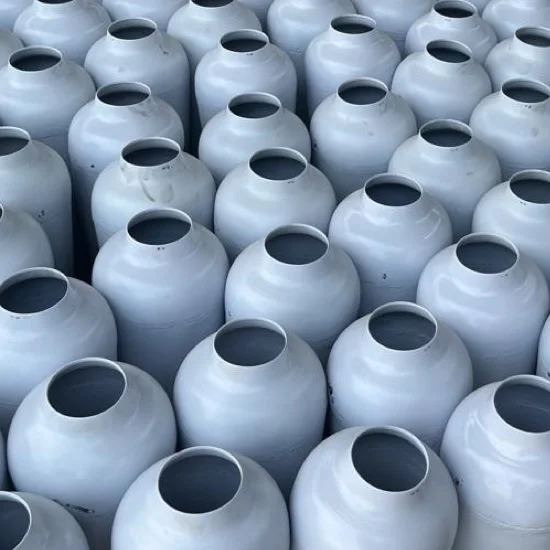 Metal vases arranged in production for surface finish consistency review